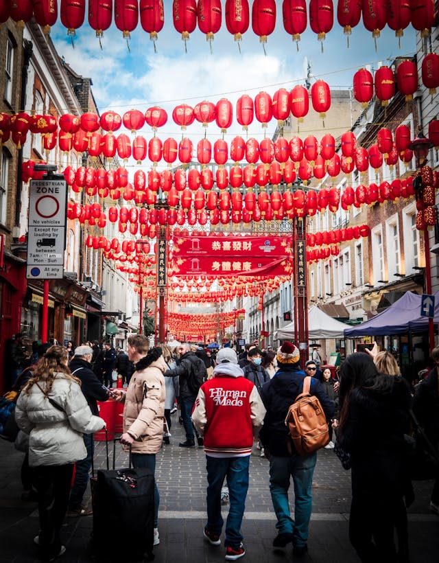 Photo by Richard Evans: https://www.pexels.com/photo/people-walking-on-street-festival-with-hanging-chinese-lanterns-11136052/